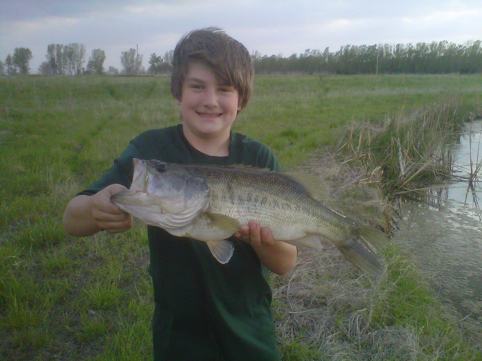 Boy holding largemouth bass